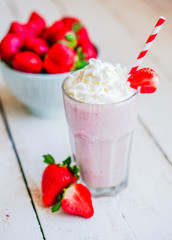 Strawberry milkshake on wooden background