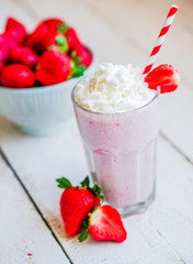 Strawberry milkshake on wooden background