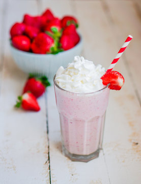 Strawberry milkshake on wooden background