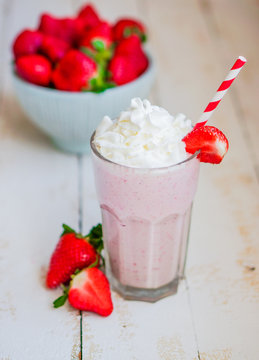 Strawberry milkshake on wooden background