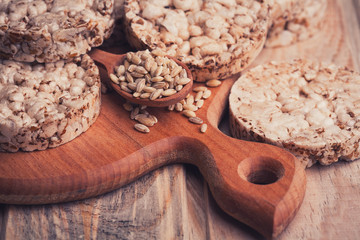 Crispbread, cereal crackers and wooden spoon with grain