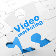 Business concept: Video Marketing on puzzle background