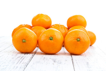 Ripe sweet tangerines on color wooden background