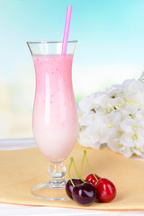 Milk shake on table on light blue background