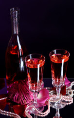 Composition with pink  wine in glasses, bottle  and  roses
