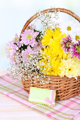 Fototapeta na wymiar Beautiful chrysanthemum flowers in wicker basket