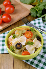 Delicious pasta with tomatoes on plate on table close-up