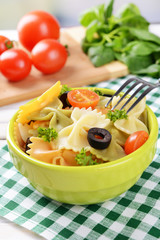 Delicious pasta with tomatoes on plate on table close-up