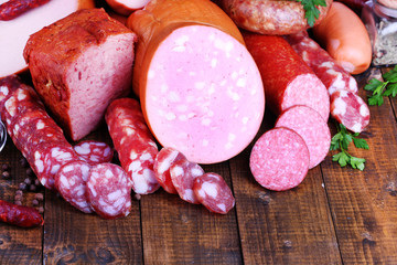 Lot of different sausages on wooden table close-up