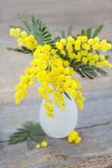 Spring flowers: mimosa in vase on wooden background - 61342737