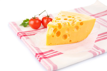 Piece of cheese and tomatoes,on color napkin, isolated on white