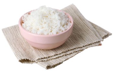 Cooked rice in bowl on napkin isolated on white