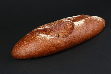 Loaf of bread on black background