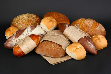 Different types of bread on black background, close-up