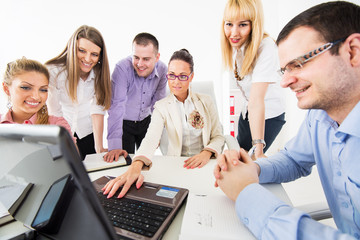Businesspeople looking at laptop