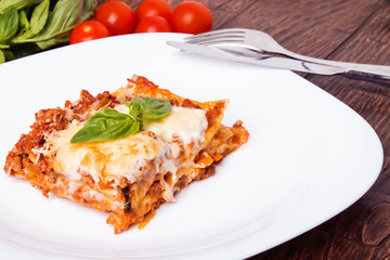 Tasty lasagna on white plate