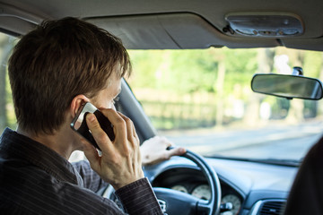 Man driving and using mobile phone