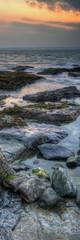 Vertical Panorama landscape of rocky coastline at sunrise