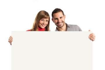 Couple holding placard over white background