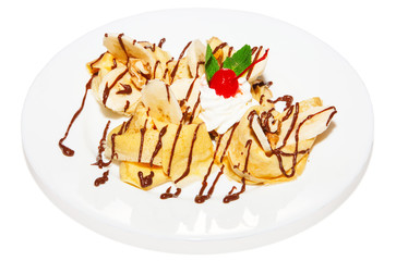 Sweet pancake with banana, chocolate syrup and cream, dessert