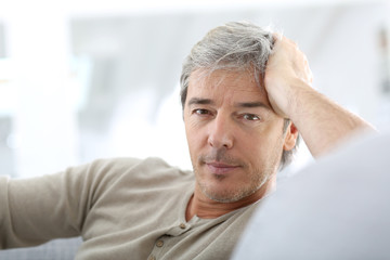 Fototapeta premium Portrait of attractive mature man relaxing at home