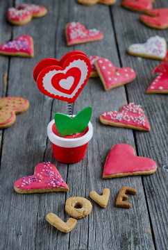 Heart shaped valentine cookies on a wooden board