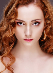 Portrait of beautiful girl with curly red hair, face closeup