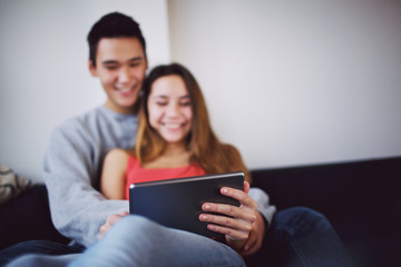 Fototapeta na wymiar Happy teenage couple movie on digital tablet