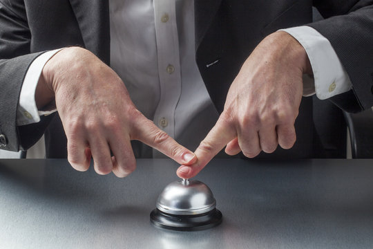 business man pressing bell with insistence