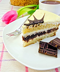 Cake with chocolate and pink tulips on the tablecloth