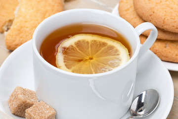 black tea with lemon and cookies, close-up