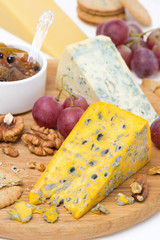 cheeses with mold, grapes, crackers, jam and nuts