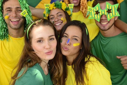 Brazilian soccer fans commemorating victory kissing.