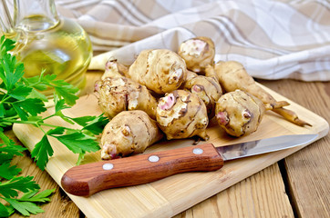 Jerusalem artichoke with a knife and oil on board