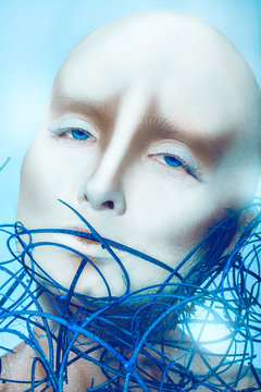 bald girl with body art on blue background