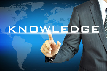 Businessman touching  KNOWLEDGE sign on virtual screen
