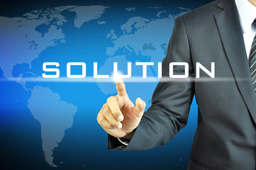 Businessman touching  SOLUTION sign on virtual screen