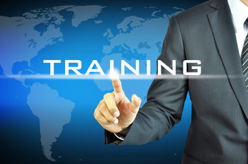 Businessman touching  TRAINING sign on virtual screen