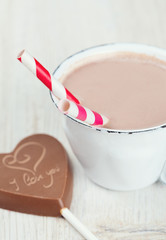 hot chocolate and chocolate heart on wooden surface