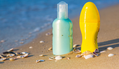 Sun protection creams on a seashore, sandy beach