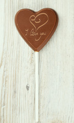 heart-shaped chocolate candy on wooden surface