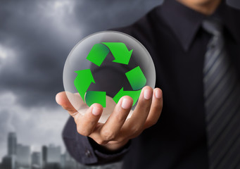 Business people holding recycle sign in crystal ball