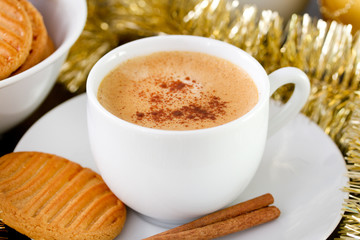 cup of coffee with cinnamon and cookies