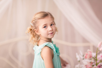 Beautiful little girl in fashion dress with spring flowers