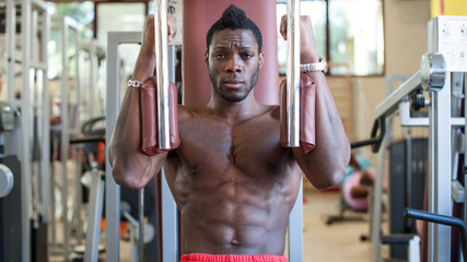 Young black man portrait exercising at the gym.