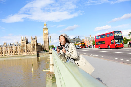 London travel woman tourist by Big Ben and red bus