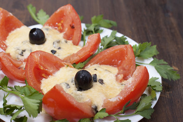 Baked tomatoes stuffed with cheese and olives.