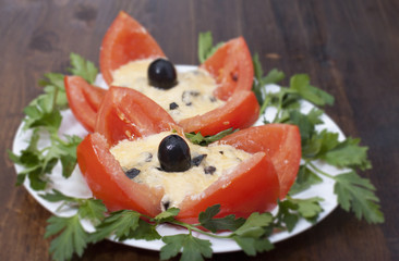 Baked tomatoes stuffed with cheese and olives.