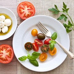 Yellow, black and red tomatoes and mozzarella