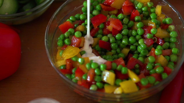 Pouring sauce on vegetable salad, super slow motion, shot at 240